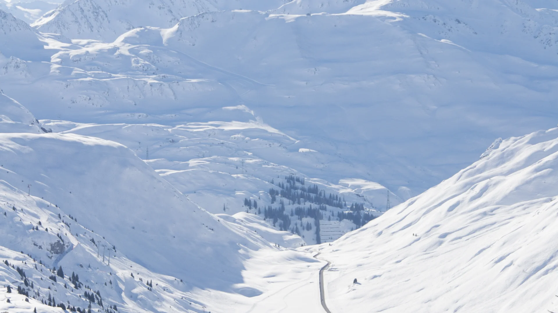 Picture gallery | Hotel Panorama in Lech am Arlberg Snow-covered mountain valley with a small settlement and road beneath high peaks