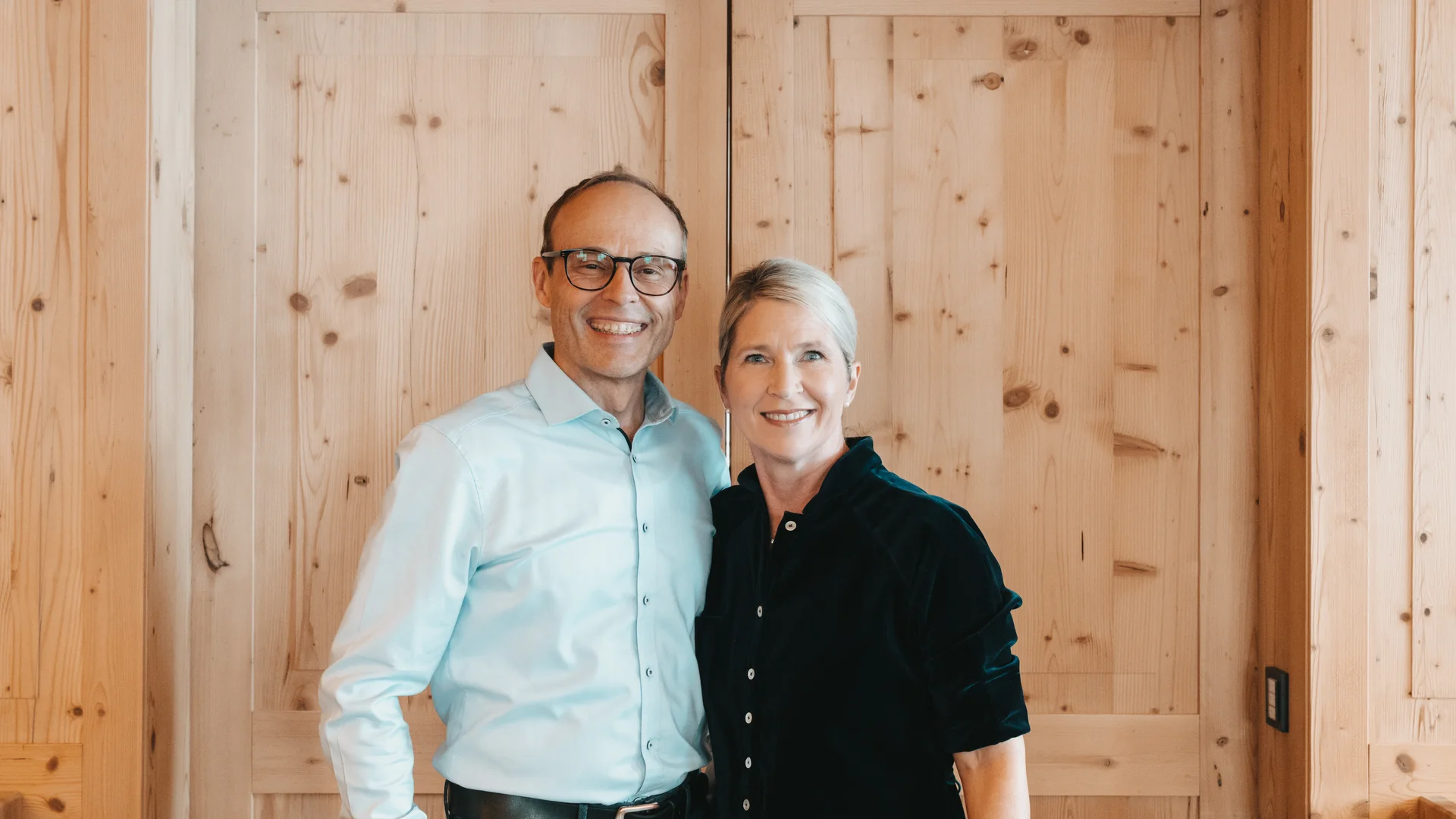 Family-run hotel in Austria | Hotel Panorama Smiling couple standing in front of a light wooden door