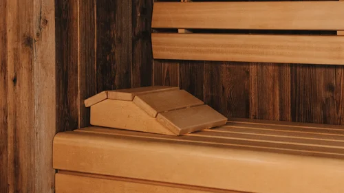 Accessibility | Hotel Panorama in Lech am Arlberg Wooden bench and paneling inside a warmly lit sauna