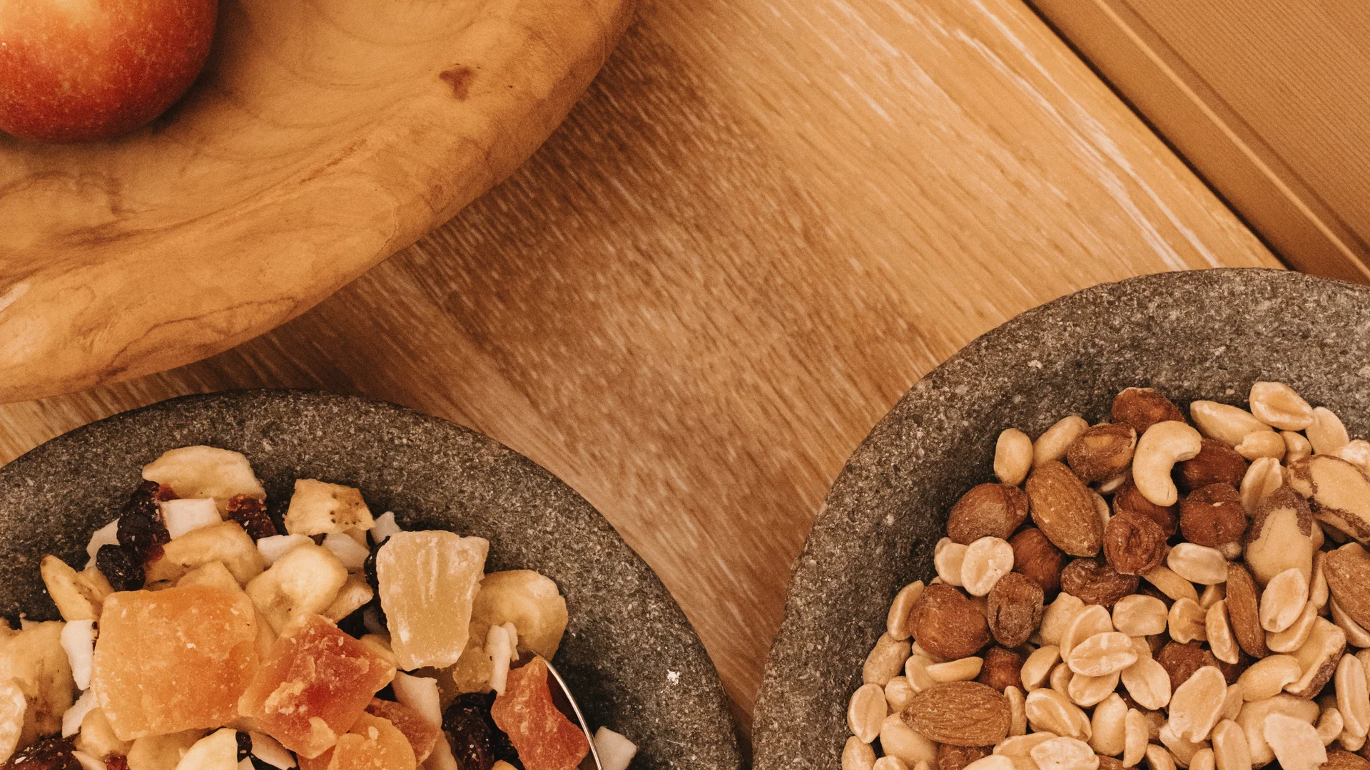 Picture gallery | Hotel Panorama in Lech am Arlberg Apples, dried fruit and nuts in bowls on a wooden table