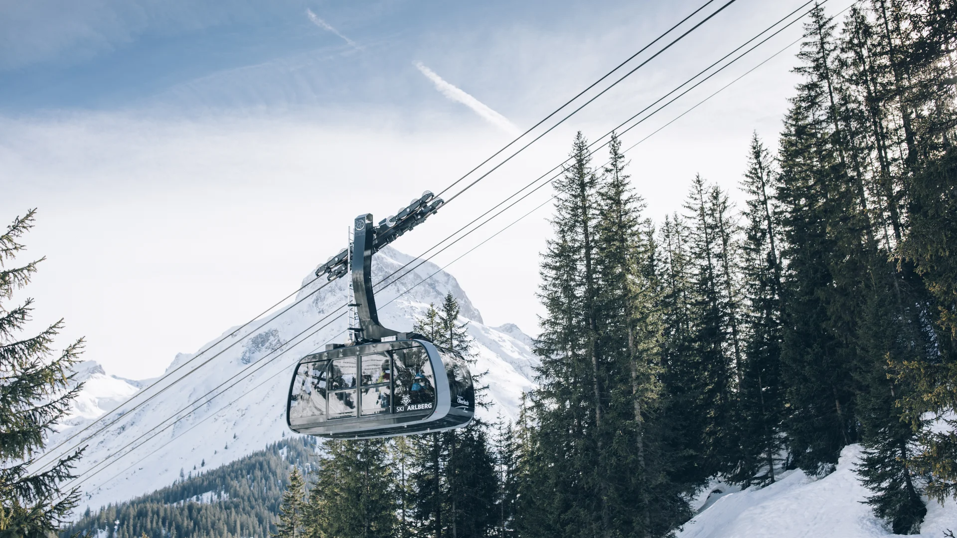 Picture gallery | Hotel Panorama in Lech am Arlberg Cable car above snow-covered fir trees with an alpine mountain backdrop