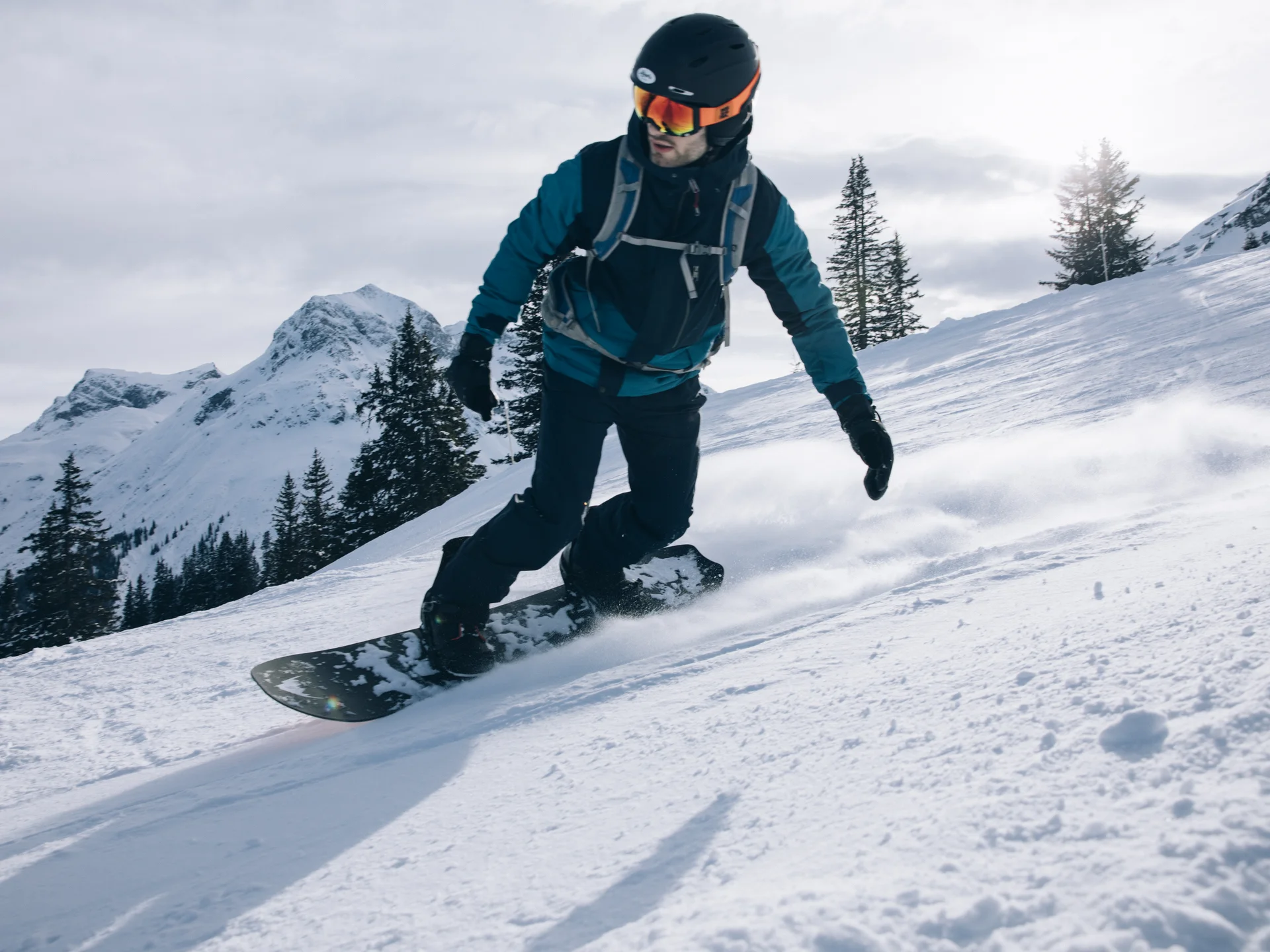 A ski holiday in Lech at Hotel Panorama Snowboarder rides down a snowy mountain slope