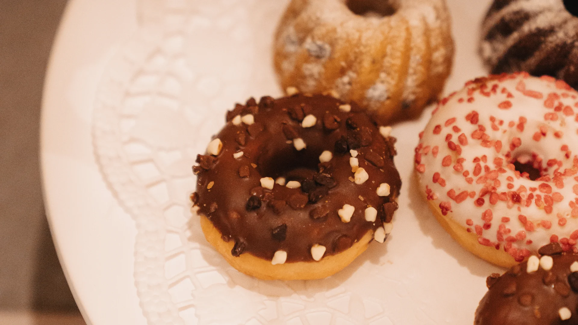 Picture gallery | Hotel Panorama in Lech am Arlberg Assorted glazed and sprinkled doughnuts on a white plate
