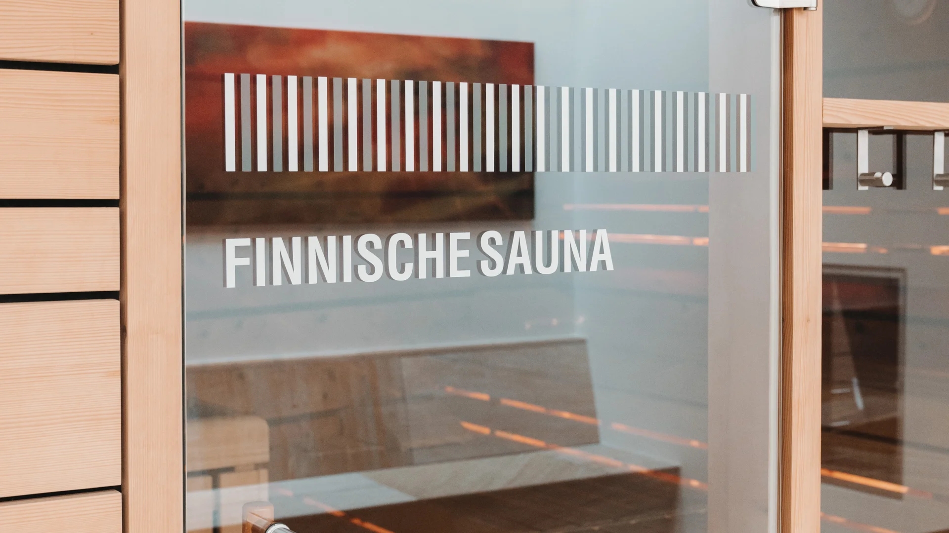 Picture gallery | Hotel Panorama in Lech am Arlberg Glass door marked Finnish sauna, with a wood-lined sauna visible behind it