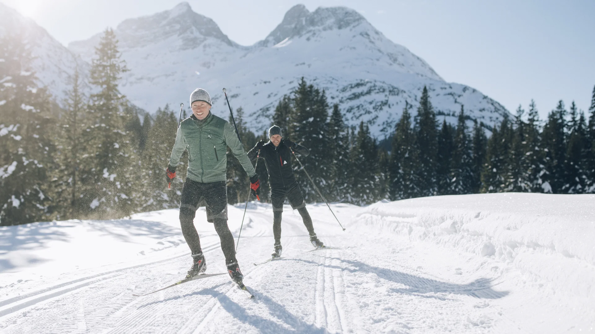 Picture gallery | Hotel Panorama in Lech am Arlberg Two cross-country skiers on a snowy trail with mountains in the background