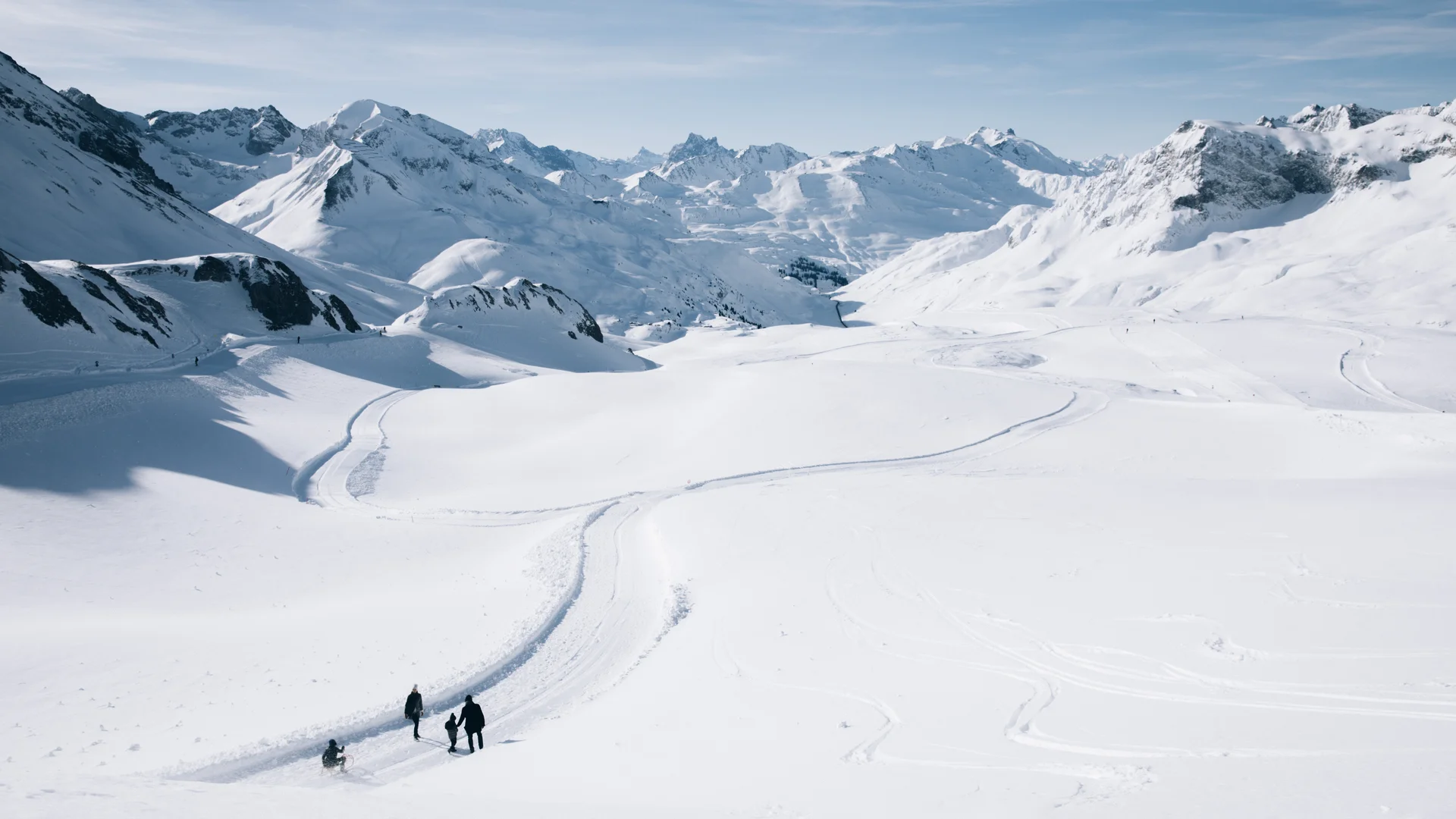 Picture gallery | Hotel Panorama in Lech am Arlberg Three people hike across a snowy mountain landscape