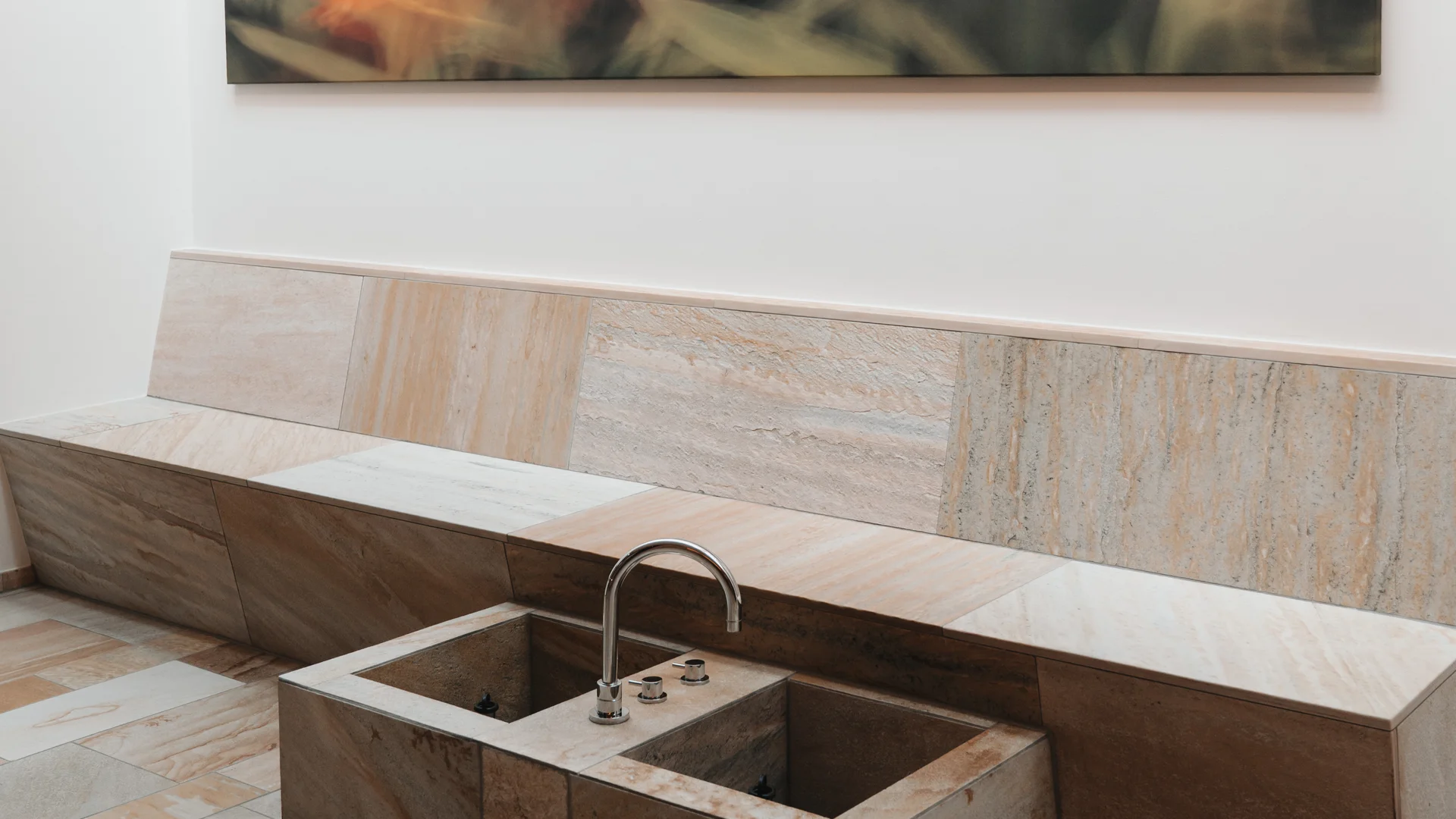 Picture gallery | Hotel Panorama in Lech am Arlberg Stone basin with a curved faucet beneath an abstract painting