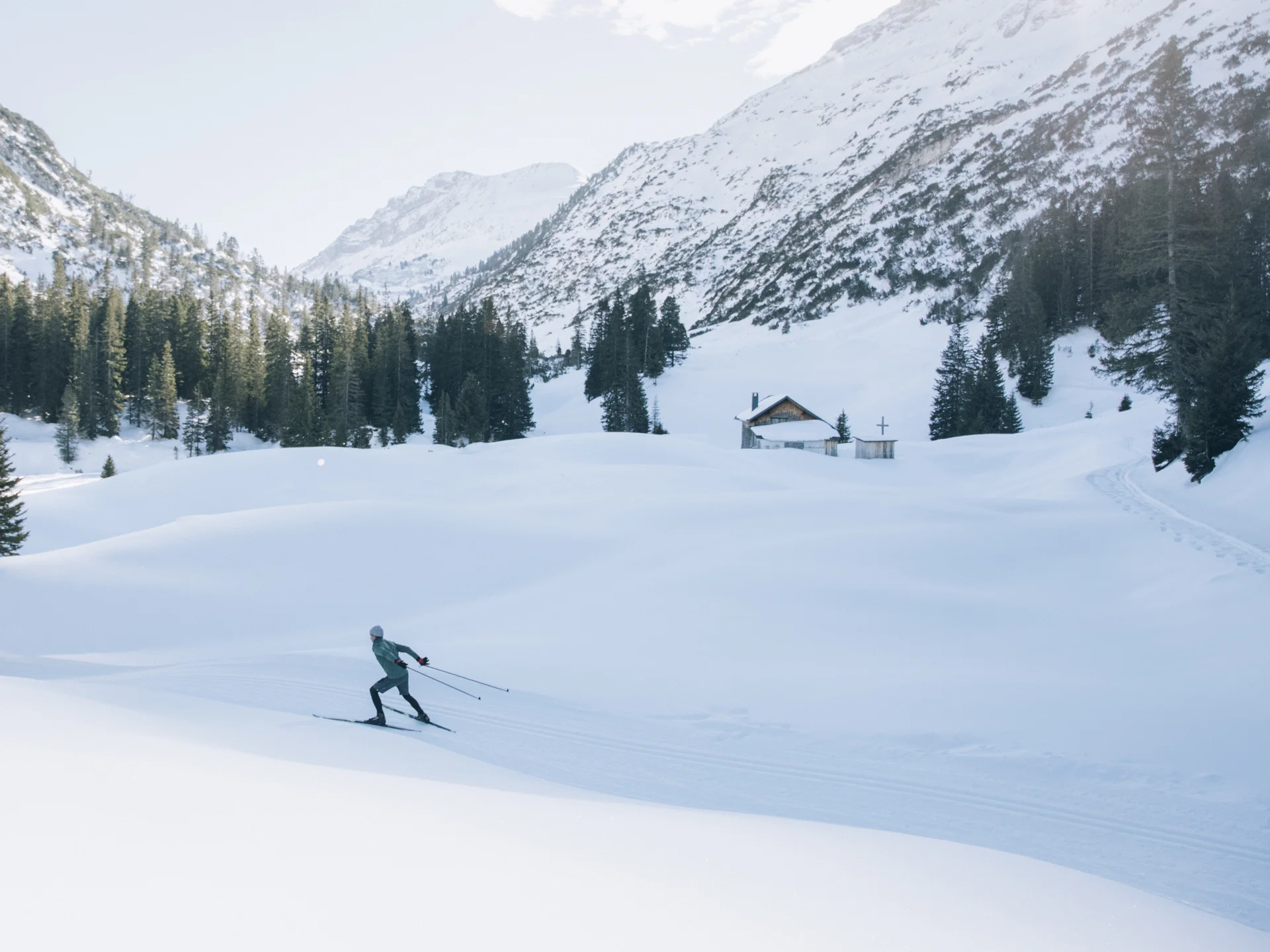 A ski holiday in Lech at Hotel Panorama A person cross-country skiing through a snowy alpine valley